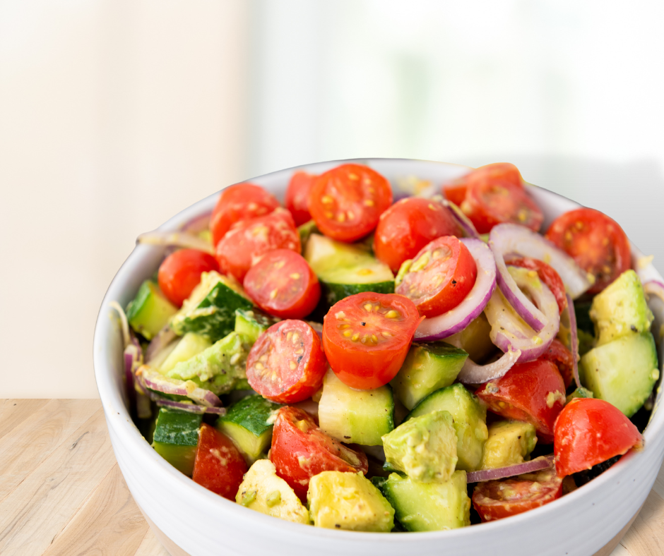 A bright white bowl filled with avocado salad